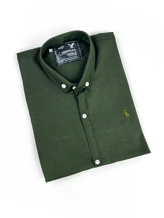 Folded green polo shirt with American Eagle logo on a white background