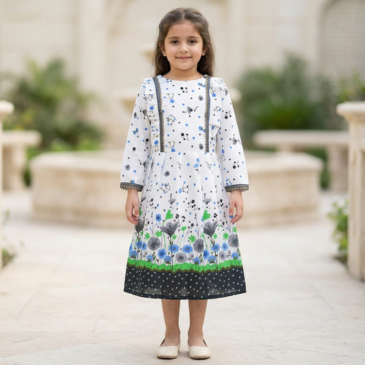Girl modelling GF63 white floral full sleeve frock with grey and blue flowers, dark lace and black hem border in a blurred garden courtyard. Shoes are styling only.
