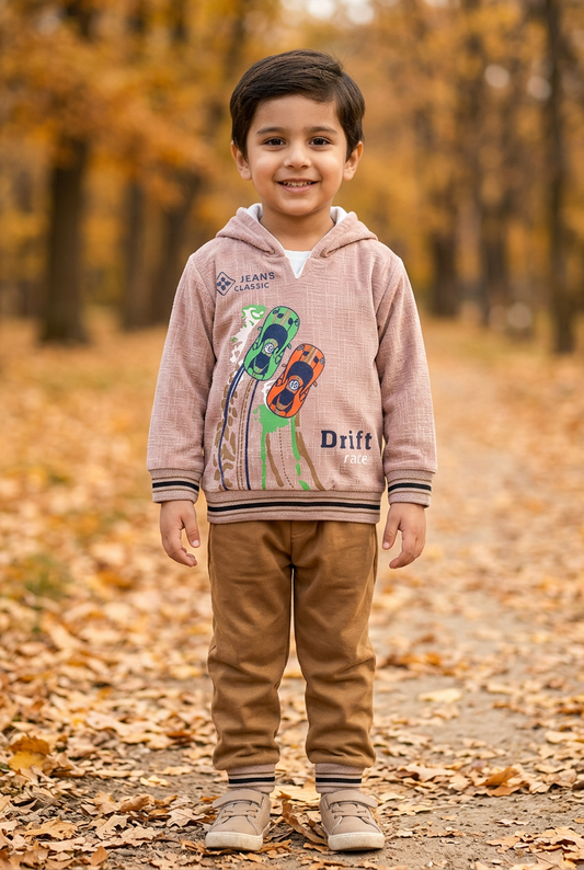 Child wearing BS811 light-peach racing-car fleece hoodie with striped trims and solid brown joggers on an autumn park path.