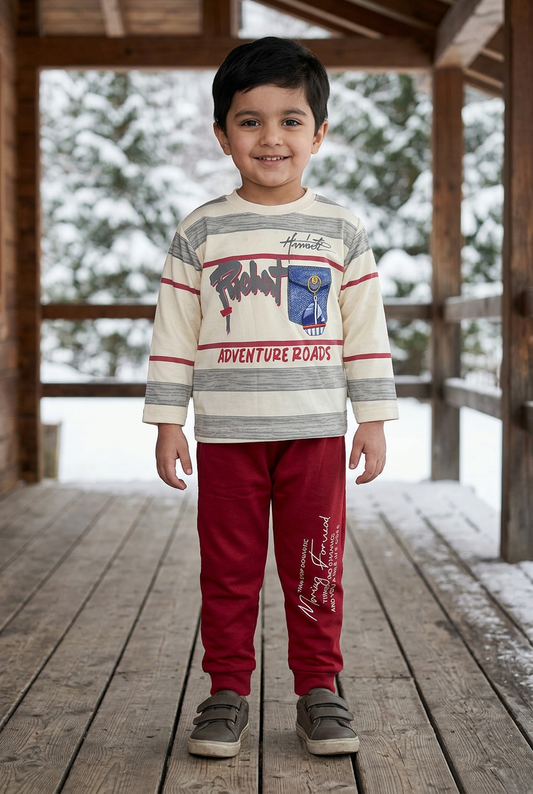 Child wearing BS798 cream striped sailboat-print Terry sweatshirt and red joggers on a sheltered wooden chalet veranda with snowy pine trees behind