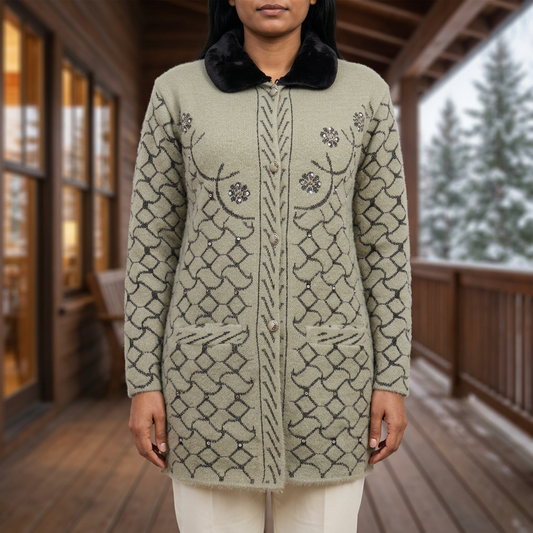 Woman modelling WSW117 light fawn full sleeve button-front sweater with dark collar and patterned details against a blurred winter veranda. Trousers are styling only.