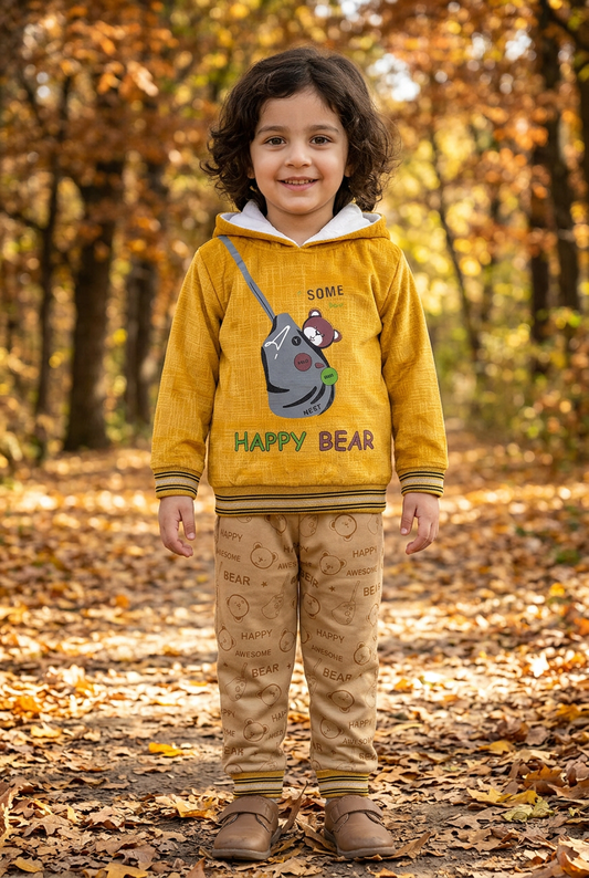 Child wearing BS818 mustard-yellow Happy Bear fleece hoodie with striped trims and beige bear-print joggers on an autumn park path.