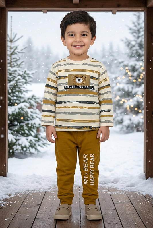 Child wearing BS784 cream striped Terry top with textured bear detail and dark-yellow joggers on a veranda overlooking snowy pines and soft lights