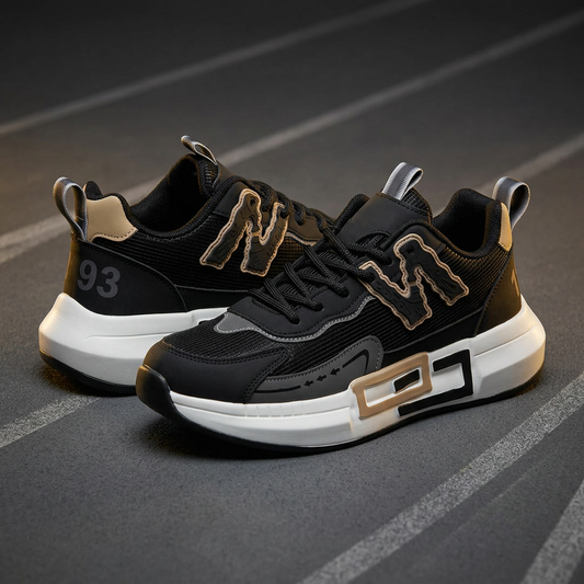 MJS243 men's black sneakers with gold-tone accents and chunky white soles with rectangular side details