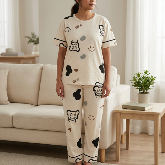 Adult woman wearing WNS75 light fawn bear-print jersey top and matching trousers in a living room