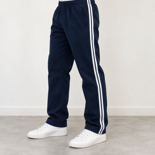 Man wearing navy blue MT249 casual trousers with double white side stripes and white sneakers, cropped to legs and feet