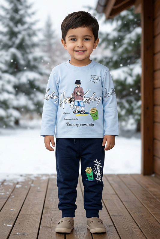Child wearing BS835 light-blue illustrated Terry sweatshirt and navy joggers with fries graphic on a sheltered veranda beside snowy pine trees
