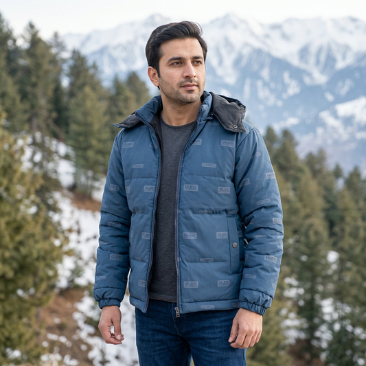 Pakistani adult man wearing blue puffer jacket MJ27 in a winter mountain setting